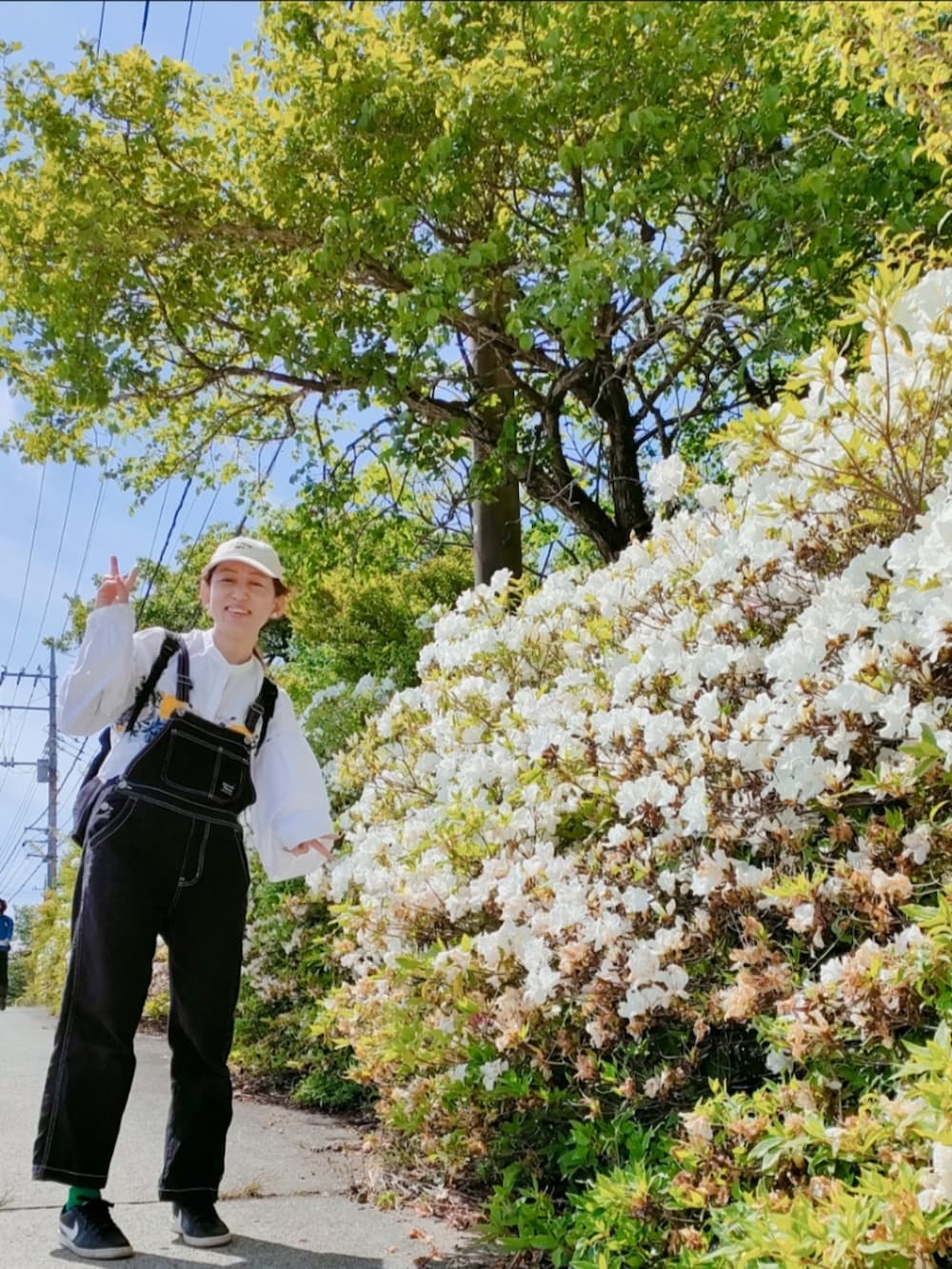 ホワイト系のシャツ/ブラウス、ブラック系のサロペット/オーバーオール、ブラック系のバックパック/リュックを着用したレディースの春コーディネートの5枚目の写真