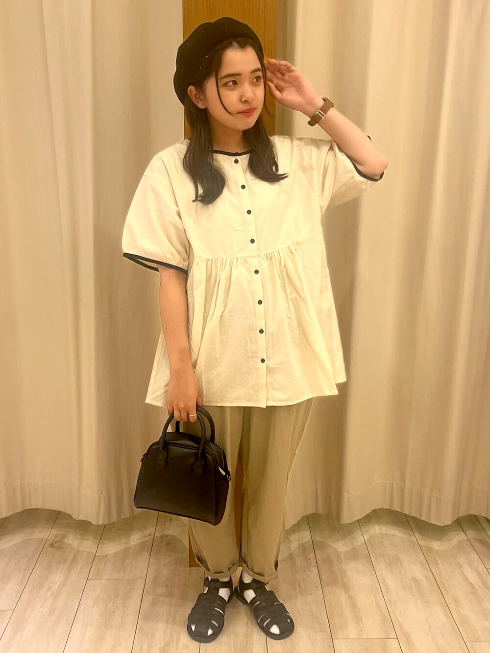 ホワイト系のシャツ/ブラウス、ブラック系のパンツ、ブラック系のハンドバッグを着用したレディースの夏コーディネートの2枚目の写真