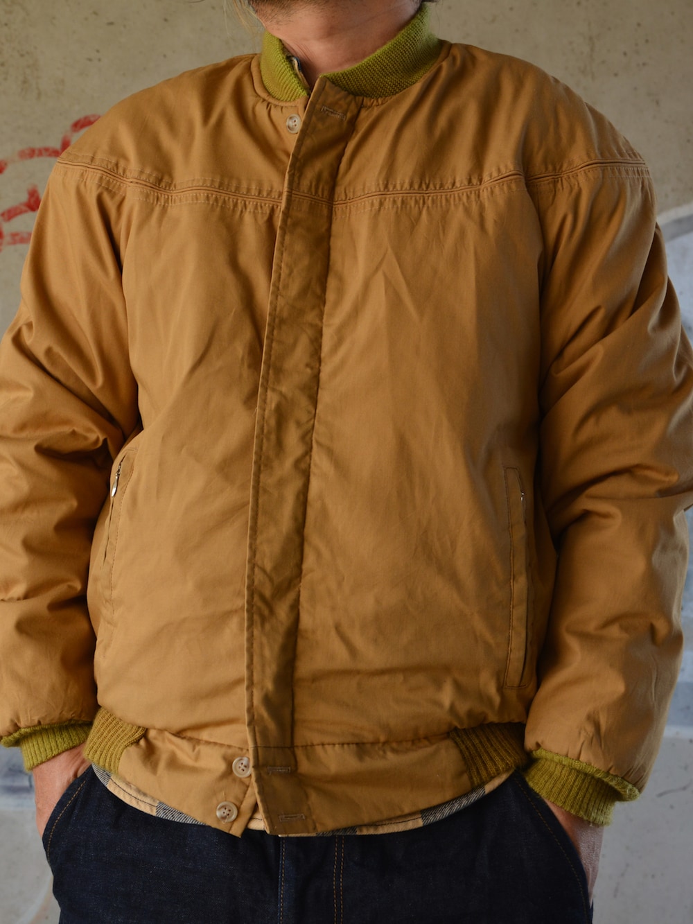 ブルー系のデニムパンツ、イエロー系のシャツ/ブラウス、ベージュ系のブルゾンを着用したメンズの秋コーディネートの2枚目の写真