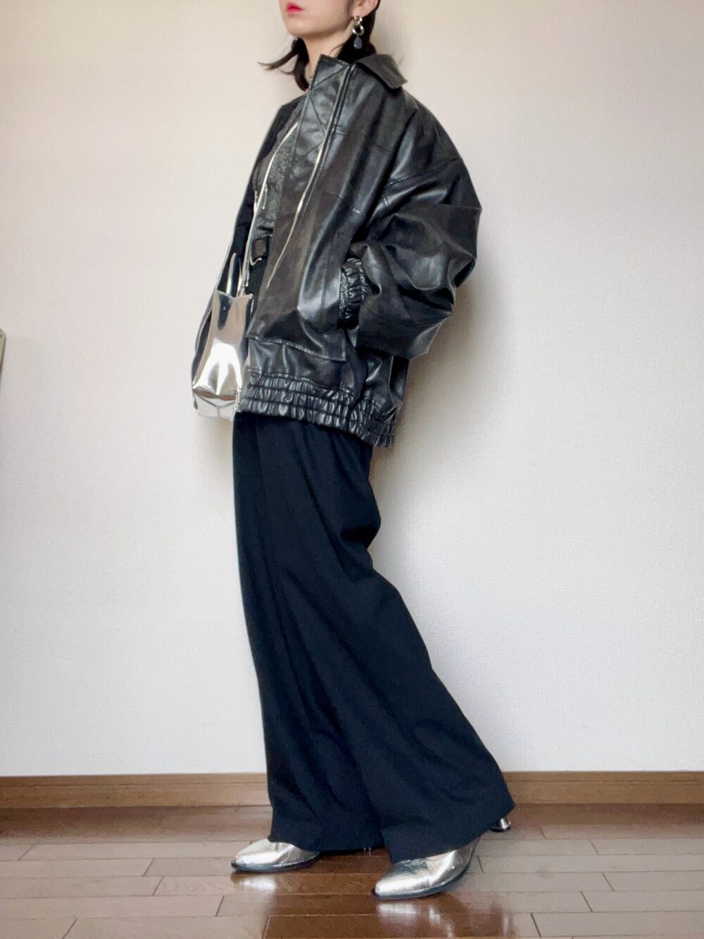ブラック系のパンツ、シルバー系のパンプス、シルバー系のショルダーバッグを着用したレディースの秋コーディネートの4枚目の写真
