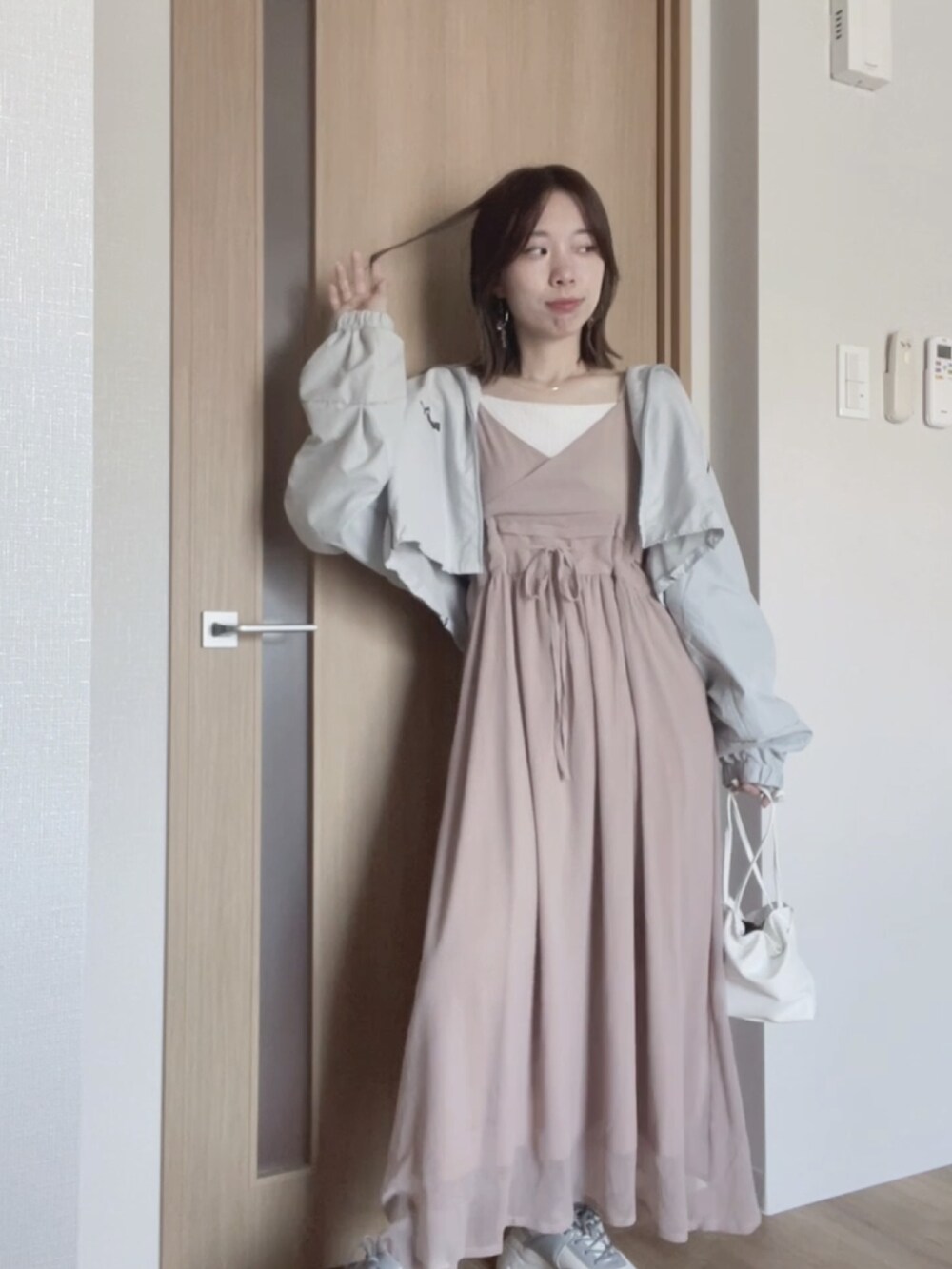 ホワイト系のバッグ、ホワイト系のスニーカー、ブルー系のジャケット/アウターを着用したレディースの秋コーディネートの3枚目の写真