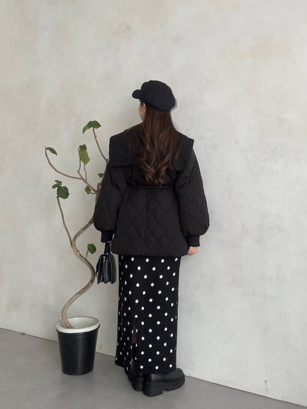 ホワイト系のニット/セーター、ブラック系のスカート、ブラック系のブーツを着用したレディースの秋コーディネートの3枚目の写真