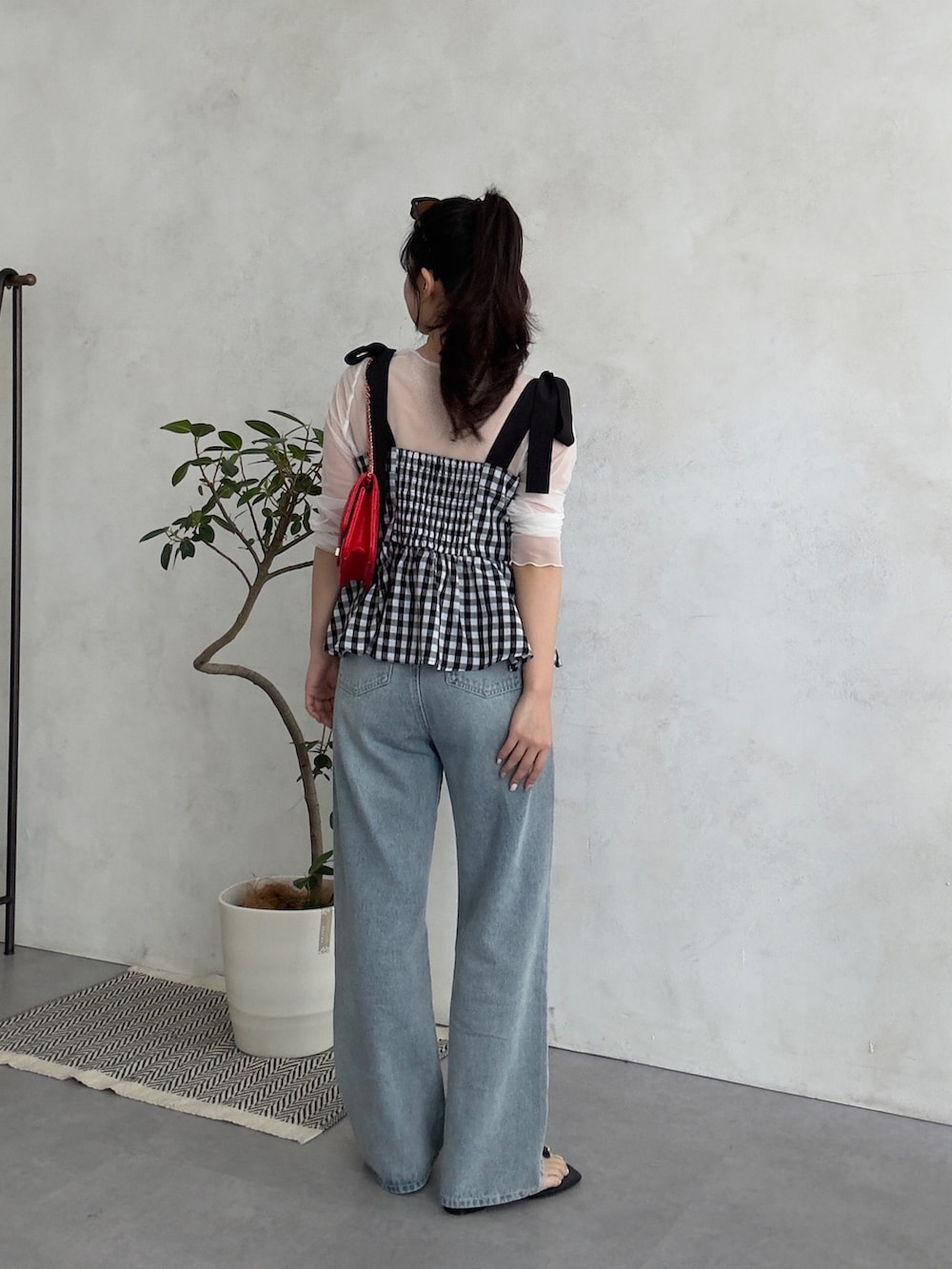 ホワイト系のTシャツ/カットソー、レッド系のトートバッグ、ブラック系のシャツ/ブラウスを着用したレディースの春コーディネートの3枚目の写真