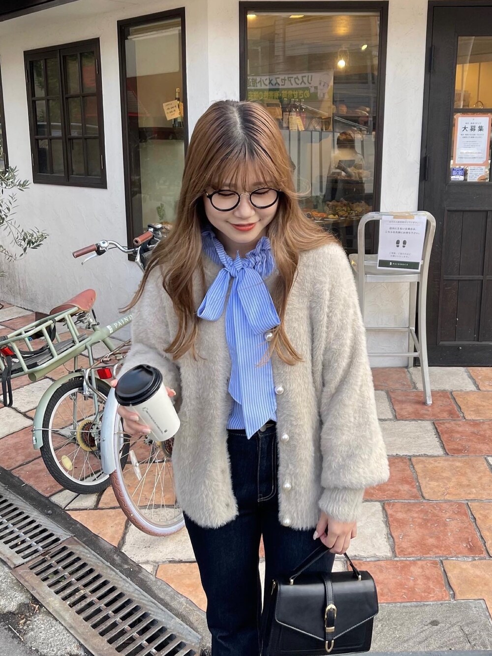 ブルー系のシャツ/ブラウス、ベージュ系のカーディガン/ボレロ、ブルー系のデニムパンツを着用したレディースの冬コーディネートの2枚目の写真