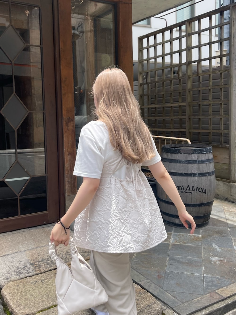ホワイト系のTシャツ/カットソー、ホワイト系のキャミソール、ホワイト系のハンドバッグを着用したレディースの夏コーディネートの2枚目の写真