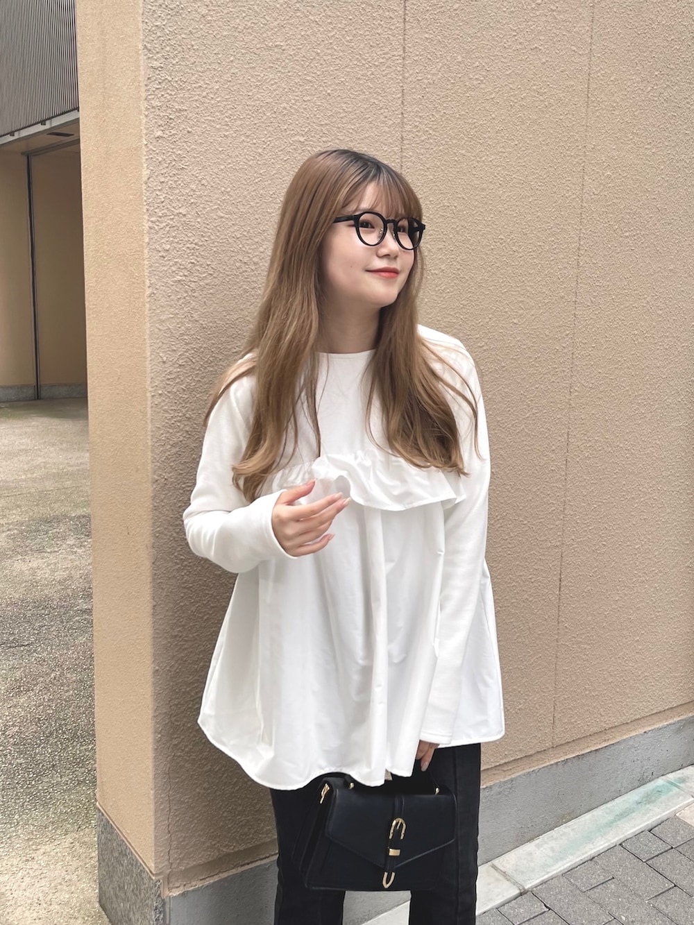 ブラック系のデニムパンツ、ホワイト系のTシャツ/カットソーを着用したレディースの冬コーディネートの2枚目の写真