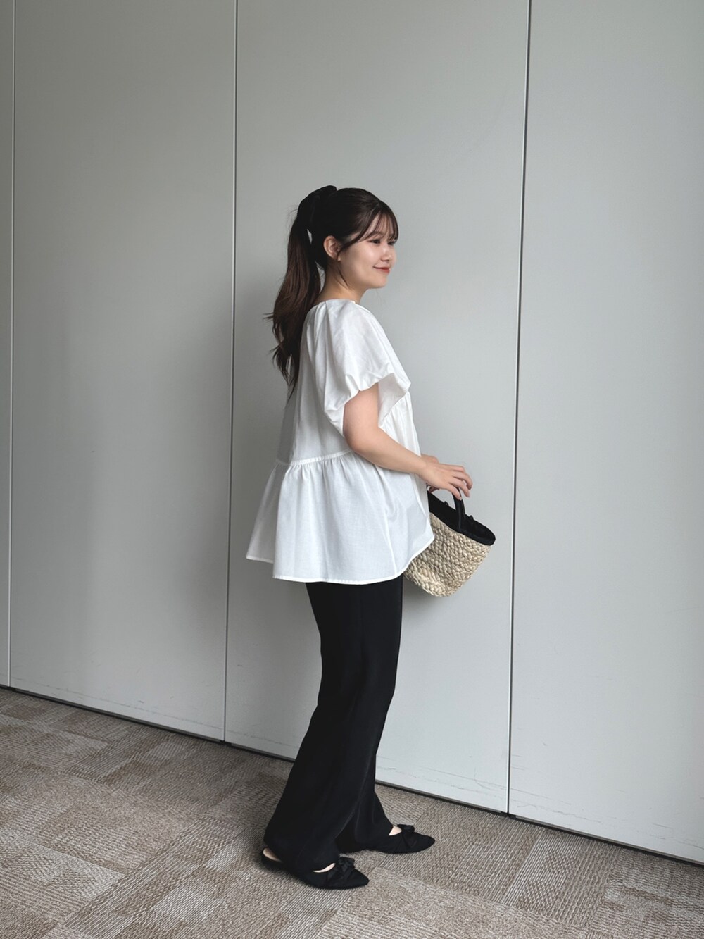 ブラック系のかごバッグ、ブラック系のその他パンツ、ブラック系のパンプスを着用したレディースの夏コーディネートの3枚目の写真
