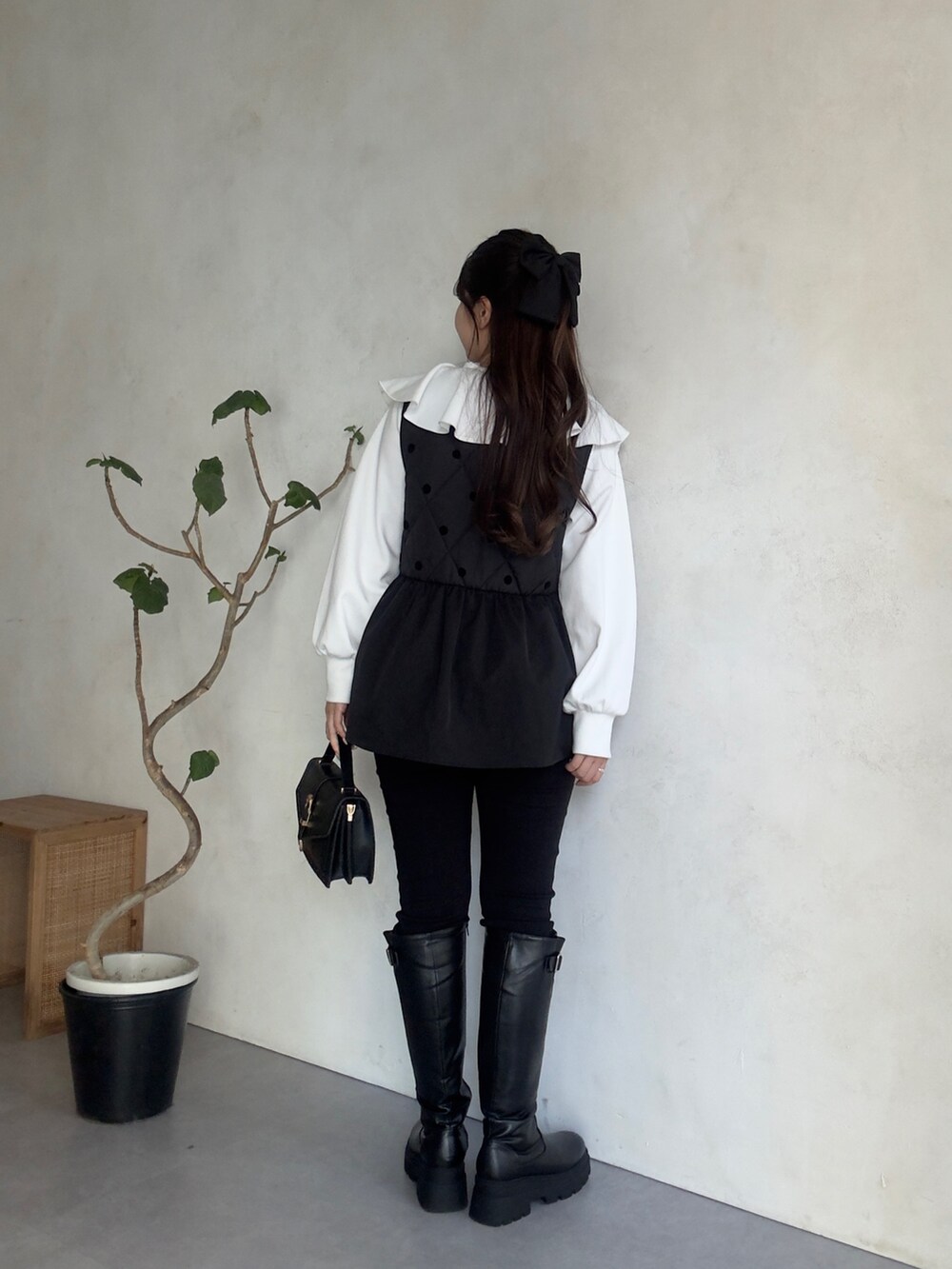 ホワイト系のスウェット、ブラック系のその他パンツ、ブラック系のブーツを着用したレディースの秋コーディネートの3枚目の写真