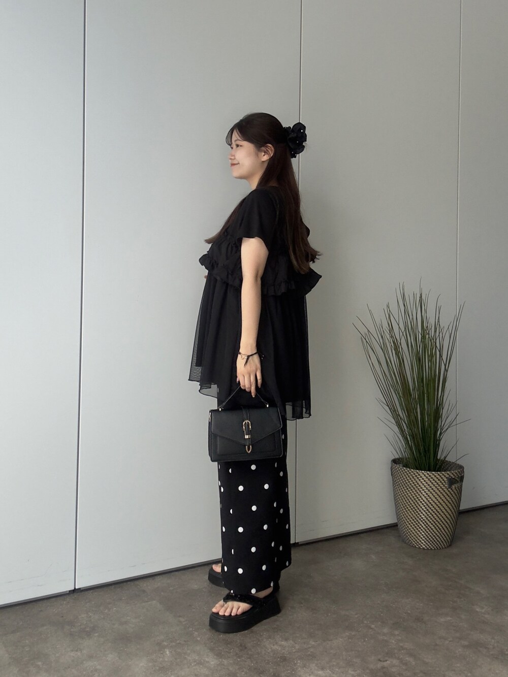 ブラック系のTシャツ/カットソー、ブラック系のスカート、ブラック系のサンダルを着用したレディースの夏コーディネートの2枚目の写真