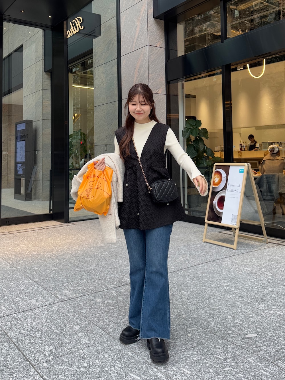 ホワイト系のその他アウター、ブルー系のデニムパンツを着用したレディースの冬コーディネートの2枚目の写真