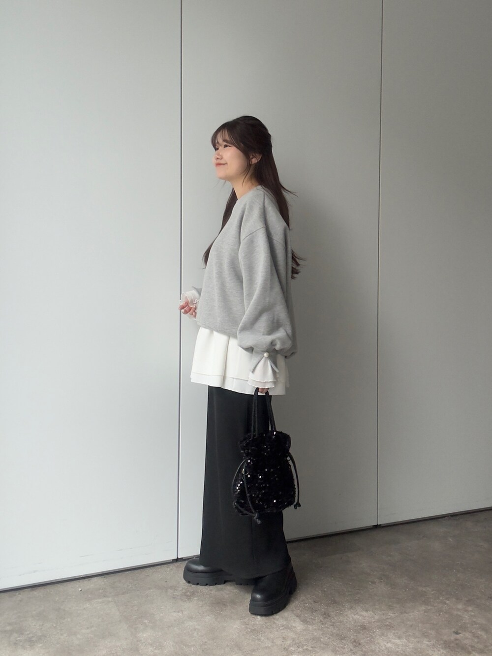 グレー系のTシャツ/カットソー、ホワイト系のTシャツ/カットソー、ブラック系のスカートを着用したレディースの冬コーディネートの2枚目の写真