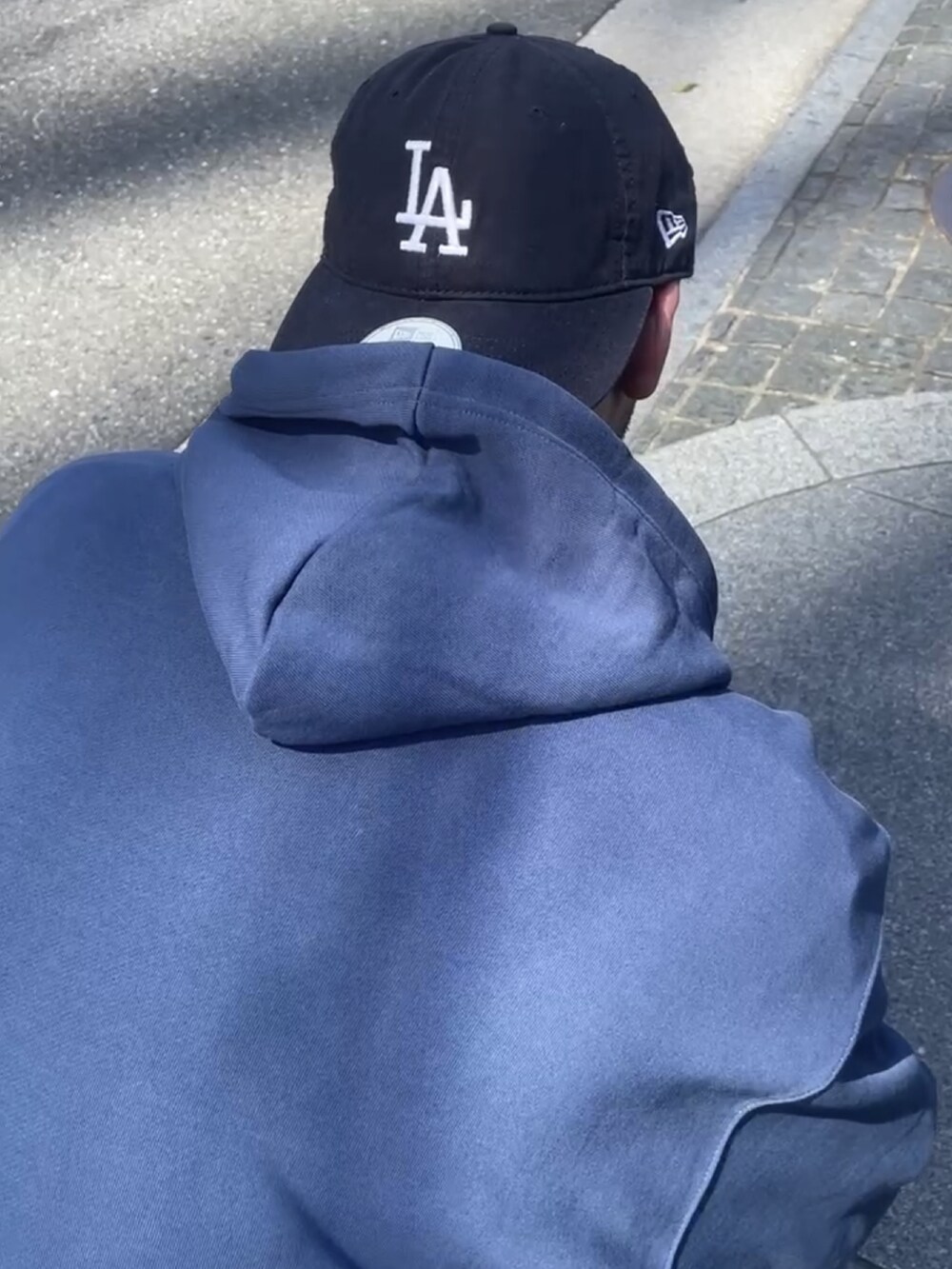 ブルー系のスニーカー、ブルー系のキャップを着用したメンズの夏コーディネートの3枚目の写真