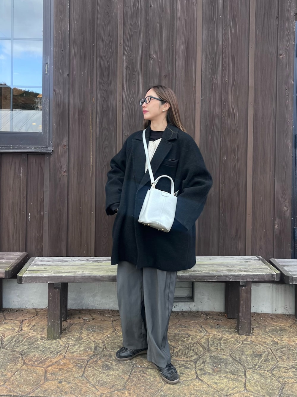 シルバー系のハンドバッグを着用したレディースの冬コーディネートの2枚目の写真