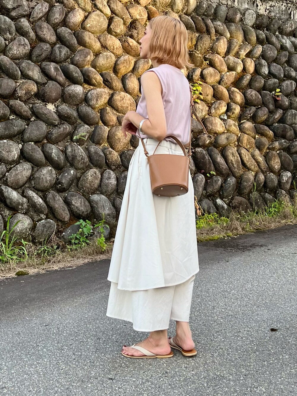 グレー系のその他パンツ、イエロー系のハンドバッグ、パープル系のTシャツ/カットソーを着用したレディースの夏コーディネートの2枚目の写真