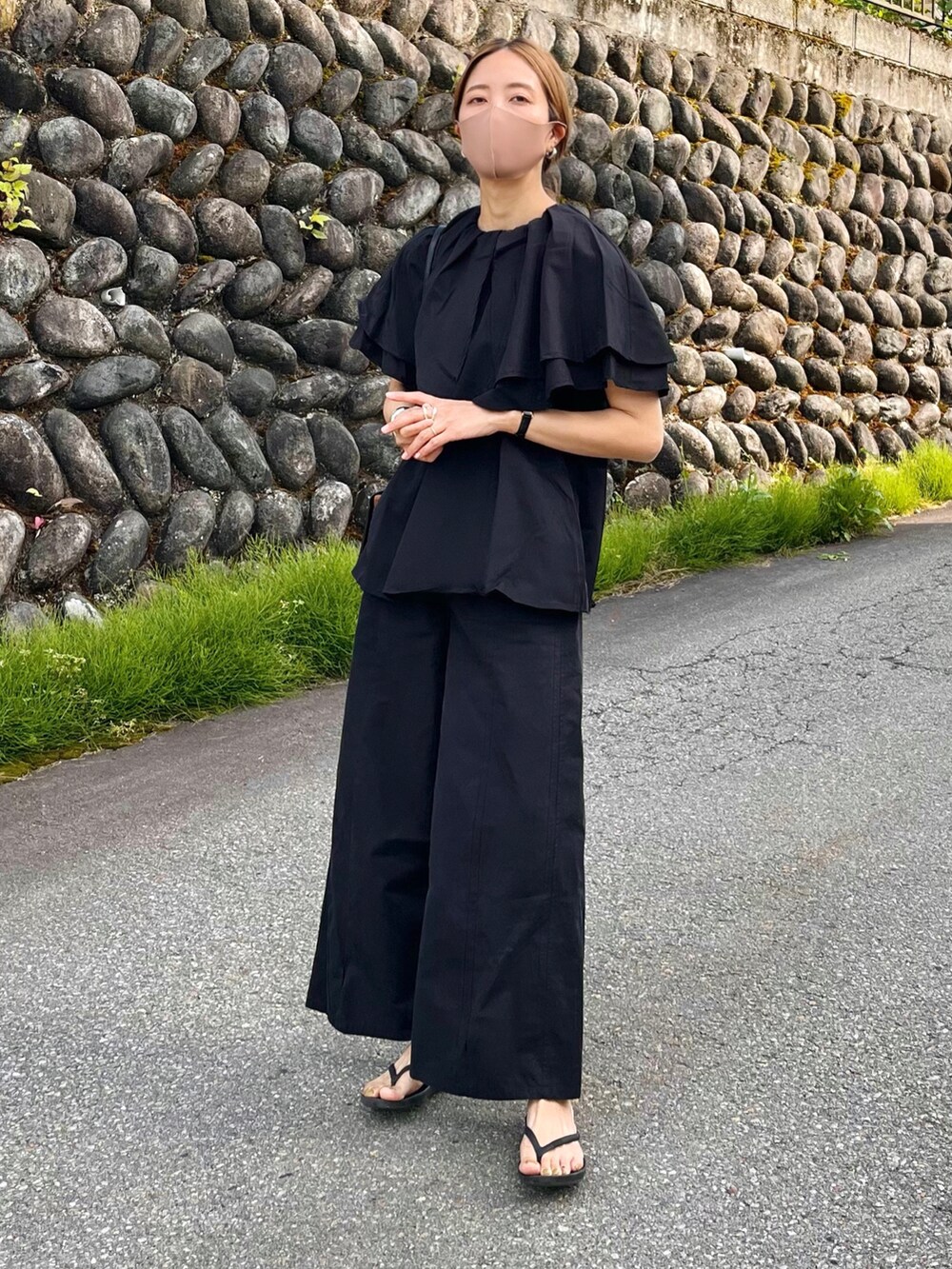 ブラック系のシャツ/ブラウス、ブラック系のショルダーバッグ、ブラック系のサンダルを着用したレディースの春コーディネートの3枚目の写真