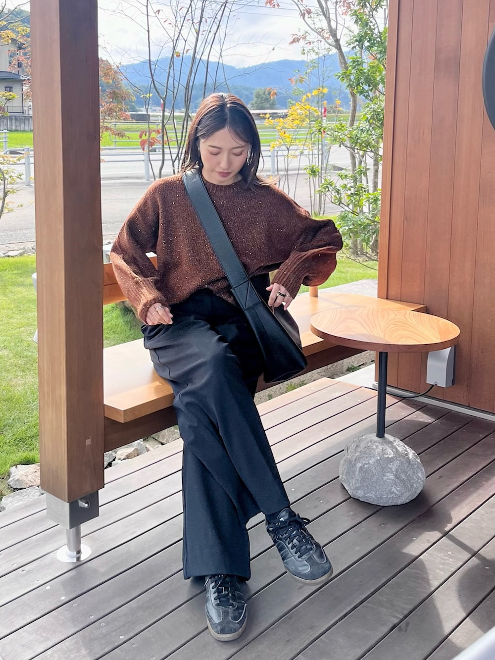 ブラウン系のニット/セーターを着用したレディースの秋コーディネートの2枚目の写真