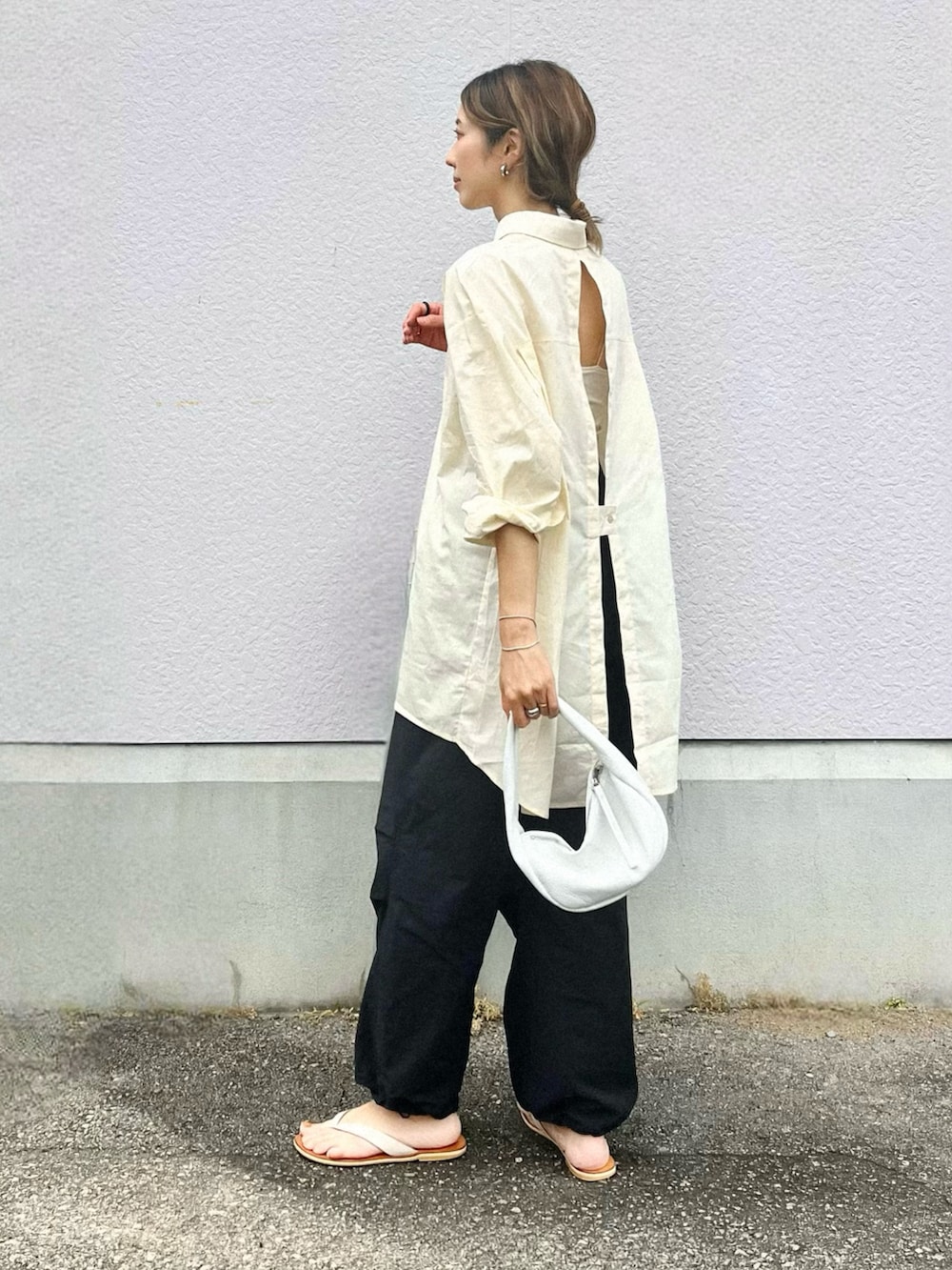 ホワイト系のシャツ/ブラウス、ホワイト系のハンドバッグ、ホワイト系のサンダルを着用したレディースの夏コーディネートの2枚目の写真