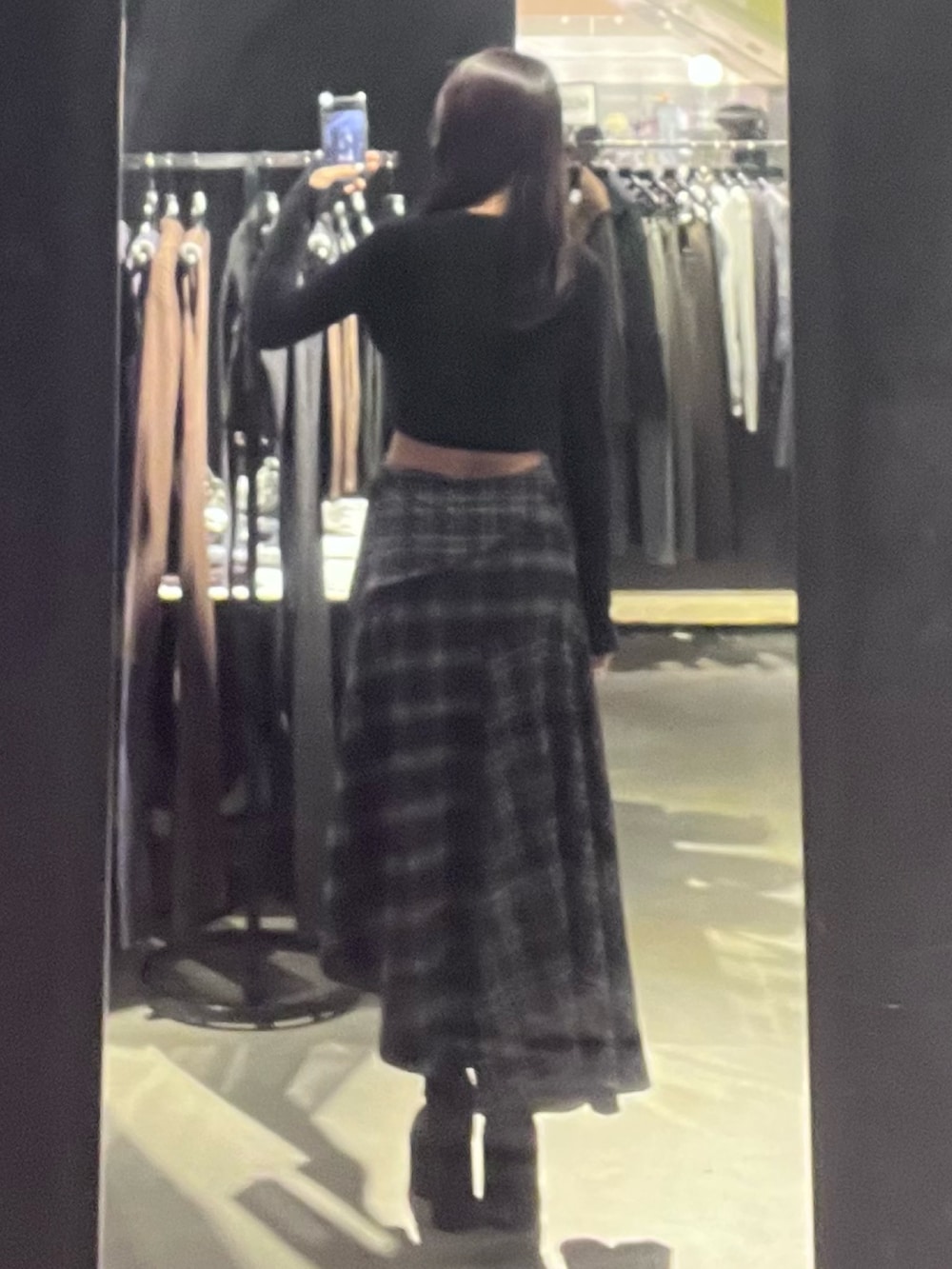 ブラック系のニット/セーター、ブラック系のスカート、ブラック系のブーツを着用したレディースの秋コーディネートの3枚目の写真