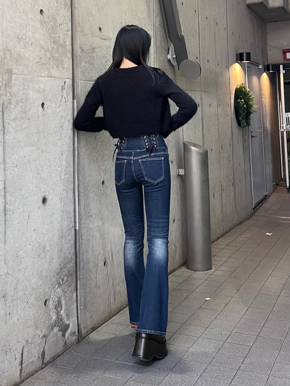 ブラック系のニット/セーター、ブルー系のデニムパンツ、その他のローファーを着用したレディースの秋コーディネートの3枚目の写真