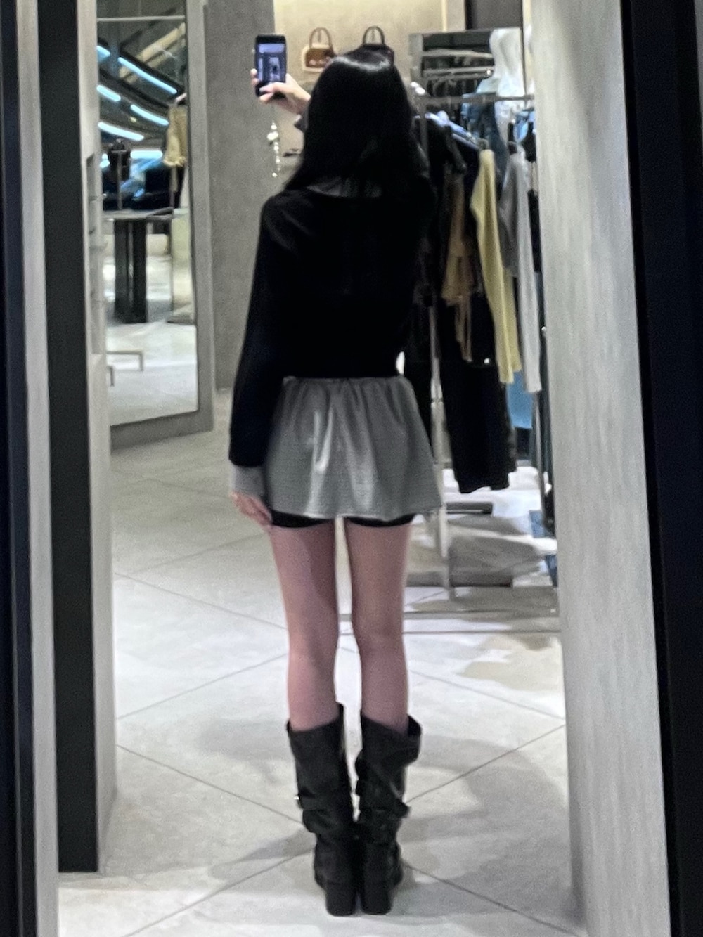 ブラック系のシャツ/ブラウス、ブラック系のスカート、ブラック系のブーツを着用したレディースの春コーディネートの3枚目の写真