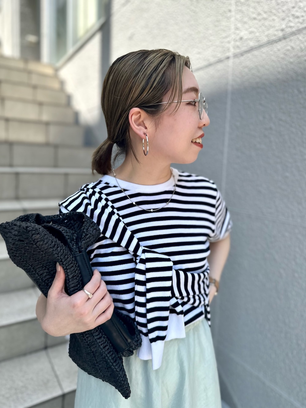 グリーン系のスカート、ブラック系のニット/セーター、ブラック系のカーディガン/ボレロを着用したレディースの夏コーディネートの8枚目の写真