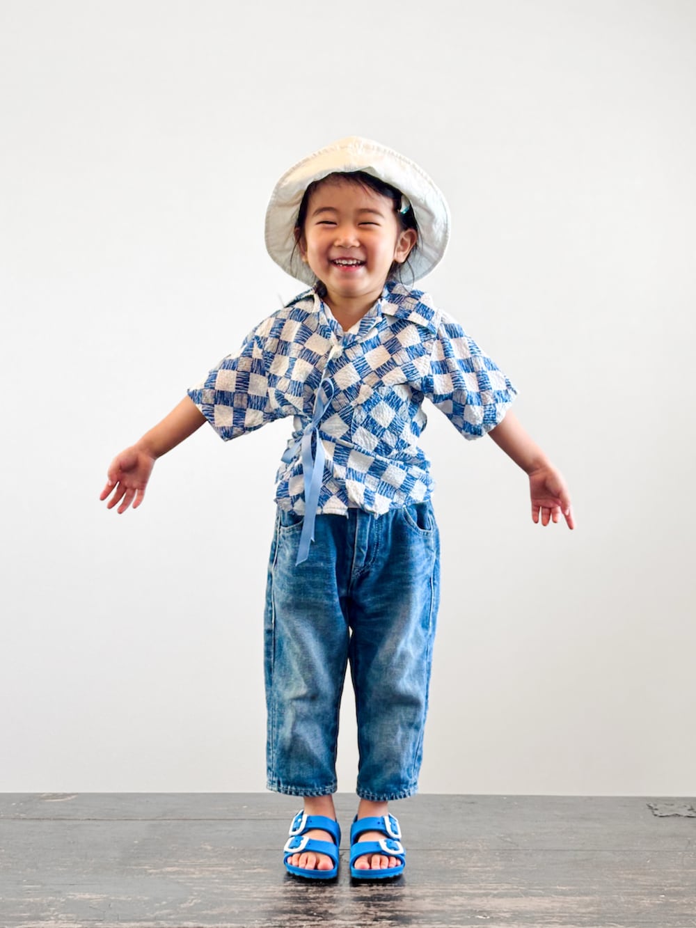 ブルー系のサンダル、ブルー系のシャツ/ブラウス、ブルー系のデニムパンツを着用したキッズの夏コーディネートの3枚目の写真