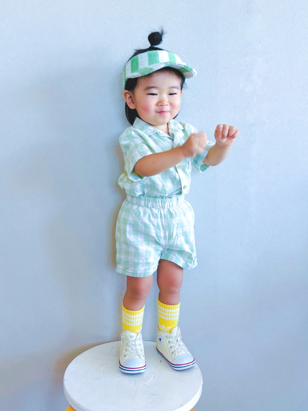 ホワイト系のスニーカー、グリーン系のセットアップ、イエロー系のソックス/靴下を着用したキッズの夏コーディネートの3枚目の写真