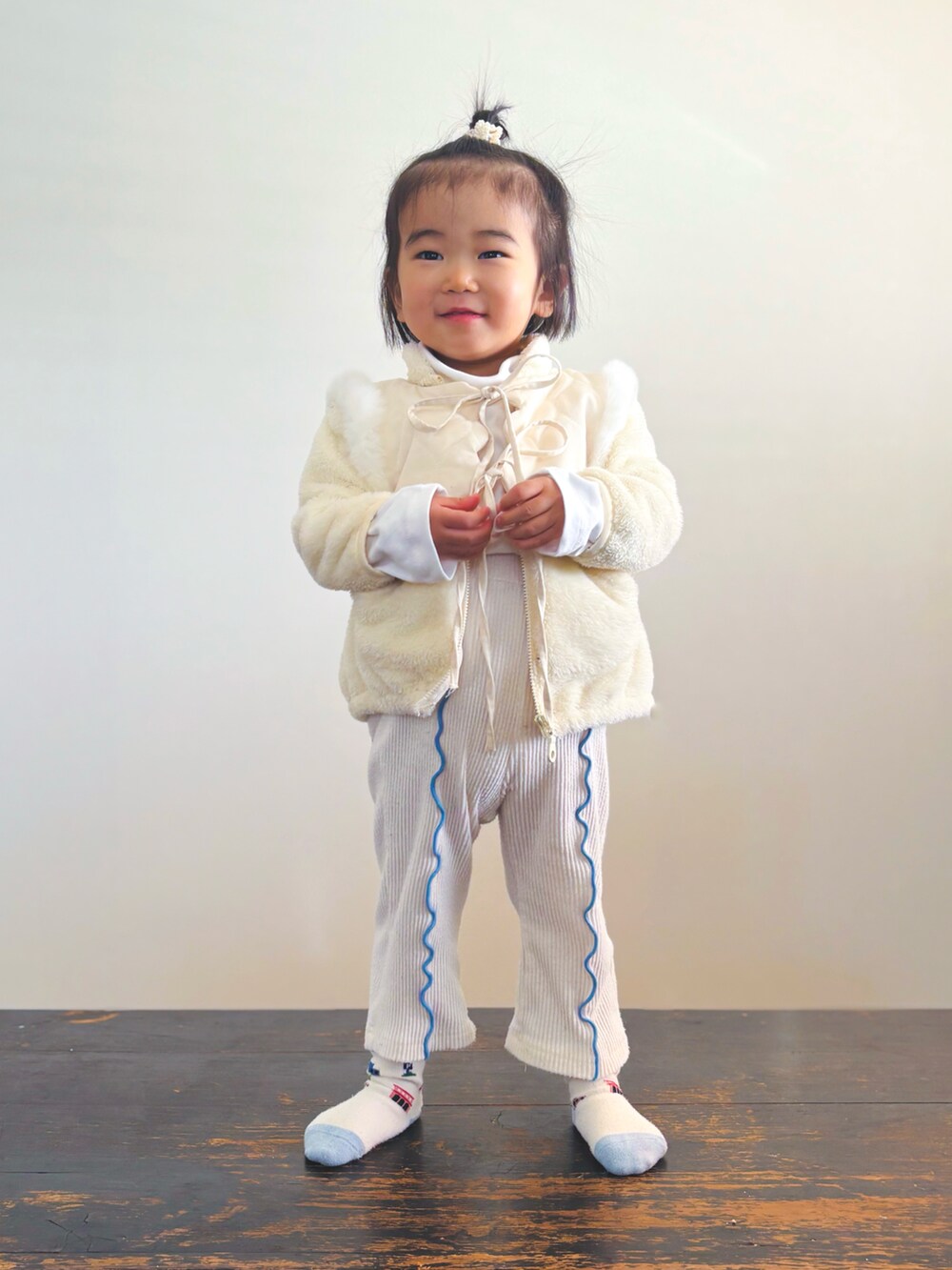 ホワイト系のジャケット/アウター、ホワイト系のベスト、ホワイト系のTシャツ/カットソーを着用したキッズの冬コーディネートの2枚目の写真