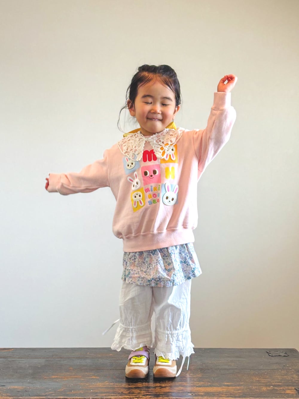 ピンク系のスウェット、ホワイト系のその他パンツ、イエロー系のスニーカーを着用したキッズの春コーディネートの3枚目の写真