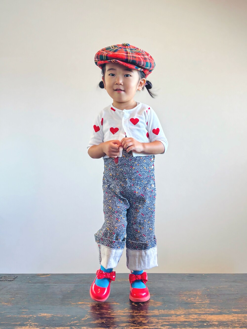 ホワイト系のカーディガン/ボレロ、その他のサロペット/オーバーオール、レッド系のドレスシューズを着用したキッズの秋コーディネートの2枚目の写真