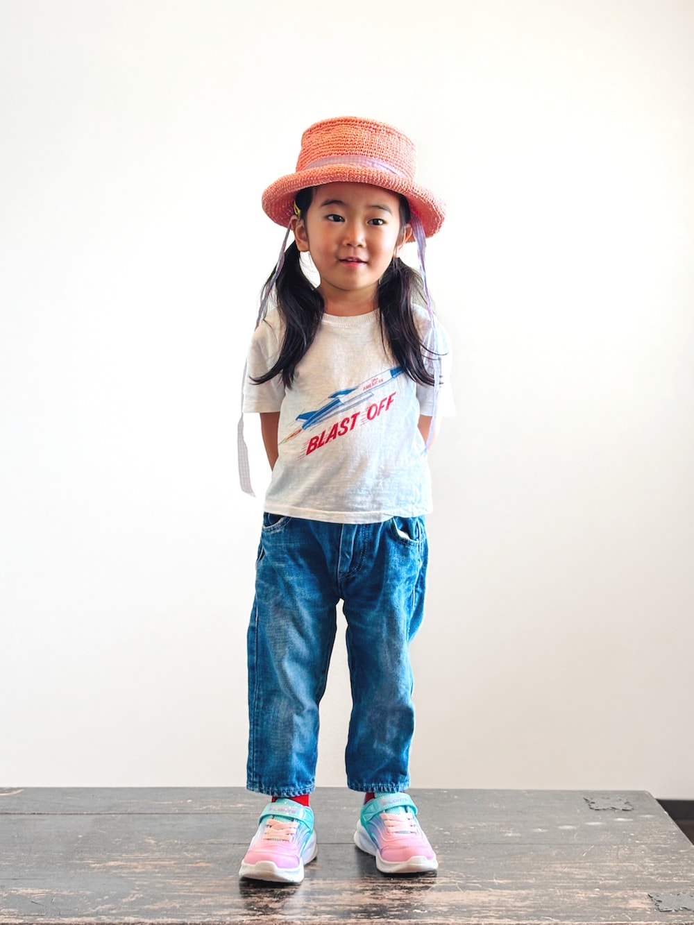 ブルー系のスニーカー、ホワイト系のTシャツ/カットソー、ブルー系のデニムパンツを着用したキッズの秋コーディネートの3枚目の写真
