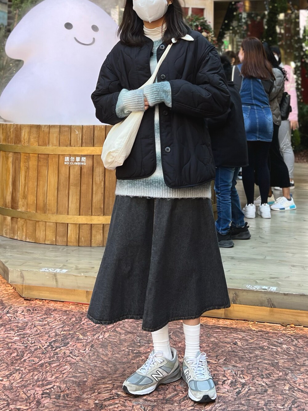 グレー系のスニーカー、ブラック系のノーカラージャケット、ホワイト系のトップスを着用したレディースの冬コーディネートの2枚目の写真