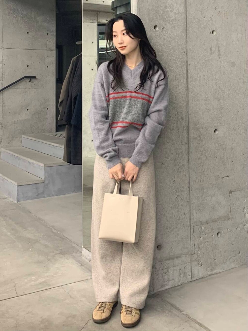 ベージュ系のその他パンツ、グレー系のニット/セーターを着用したレディースの冬コーディネートの2枚目の写真