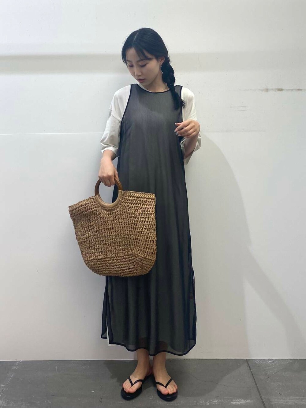 ベージュ系のトートバッグ、ブラック系のサンダル、ブラック系のワンピースを着用したレディースの夏コーディネートの4枚目の写真