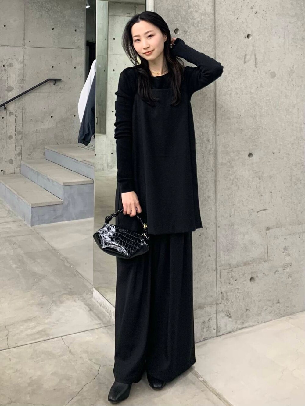 ブラック系のブーツ、ブラック系のその他パンツ、ブラック系のショルダーバッグを着用したレディースの冬コーディネートの2枚目の写真