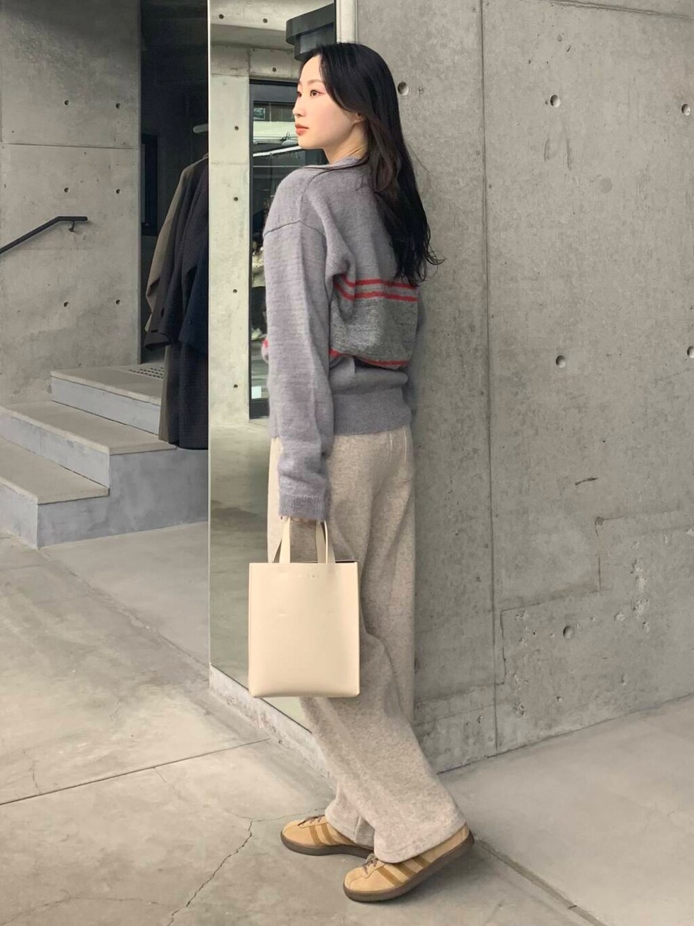 ベージュ系のその他パンツ、グレー系のニット/セーターを着用したレディースの冬コーディネートの6枚目の写真