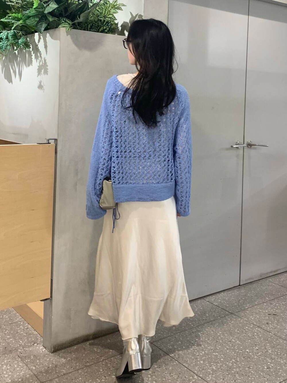 ホワイト系のスカート、シルバー系のショルダーバッグ、ホワイト系のTシャツ/カットソーを着用したレディースの冬コーディネートの6枚目の写真