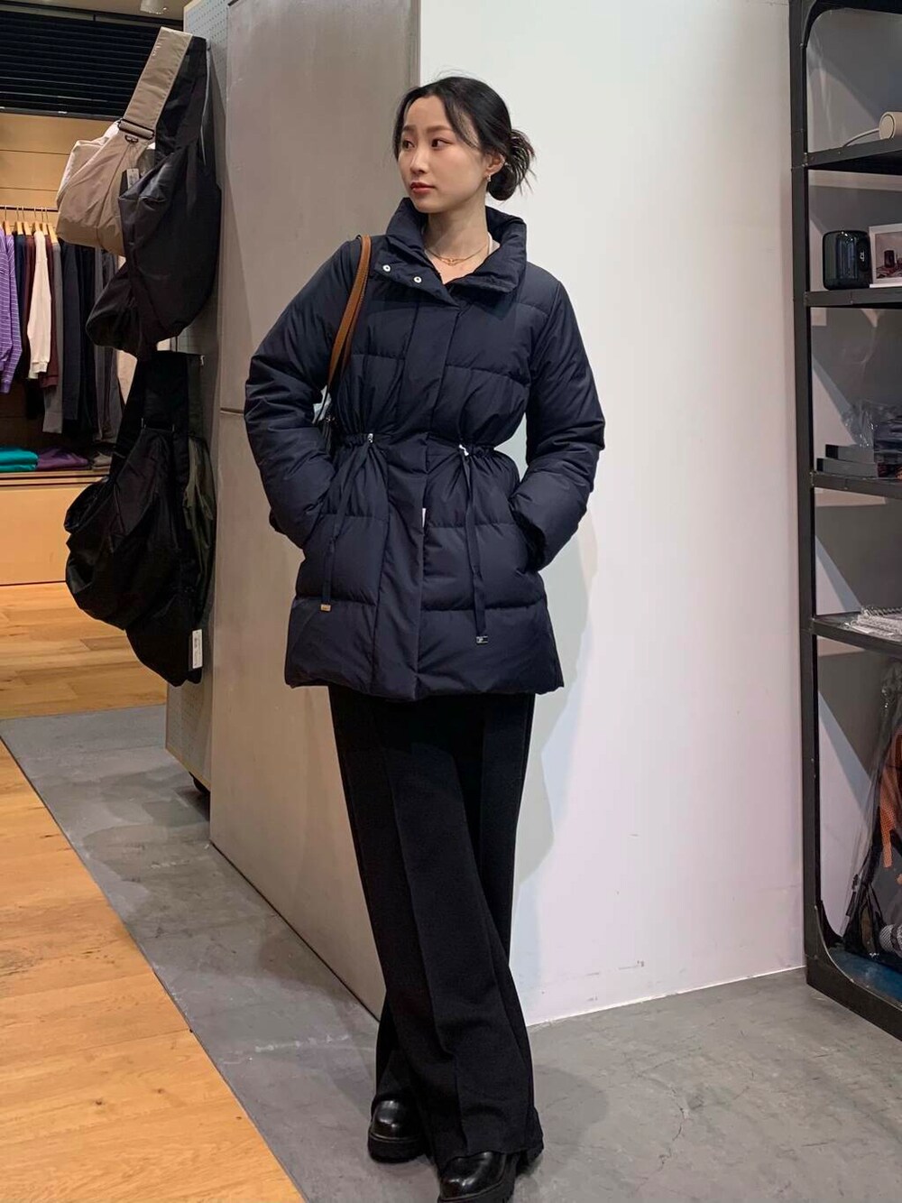 ブラック系のブーツ、ブラック系のその他パンツ、ブラック系のボストンバッグを着用したレディースの冬コーディネートの2枚目の写真