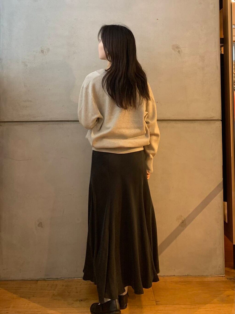 グレー系のスカート、ベージュ系のタンクトップ、ベージュ系のニット/セーターを着用したレディースの秋コーディネートの7枚目の写真
