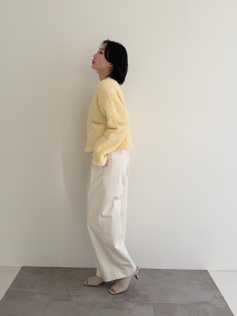 ホワイト系のその他パンツ、イエロー系のカーディガン/ボレロを着用したレディースの冬コーディネートの3枚目の写真