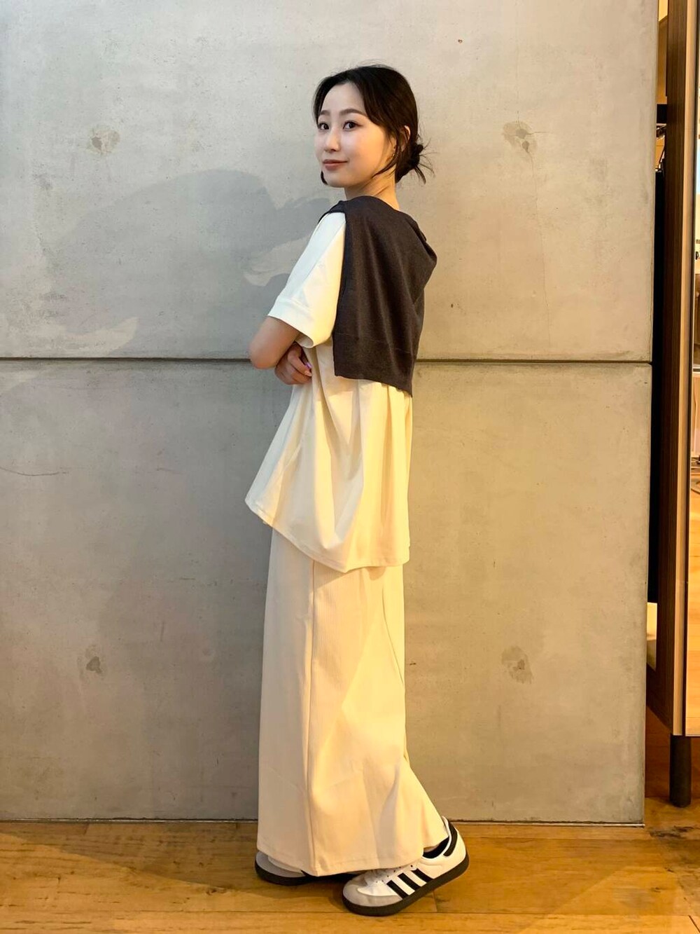 ホワイト系のスカート、グレー系のカーディガン/ボレロ、ホワイト系のTシャツ/カットソーを着用したレディースの夏コーディネートの2枚目の写真