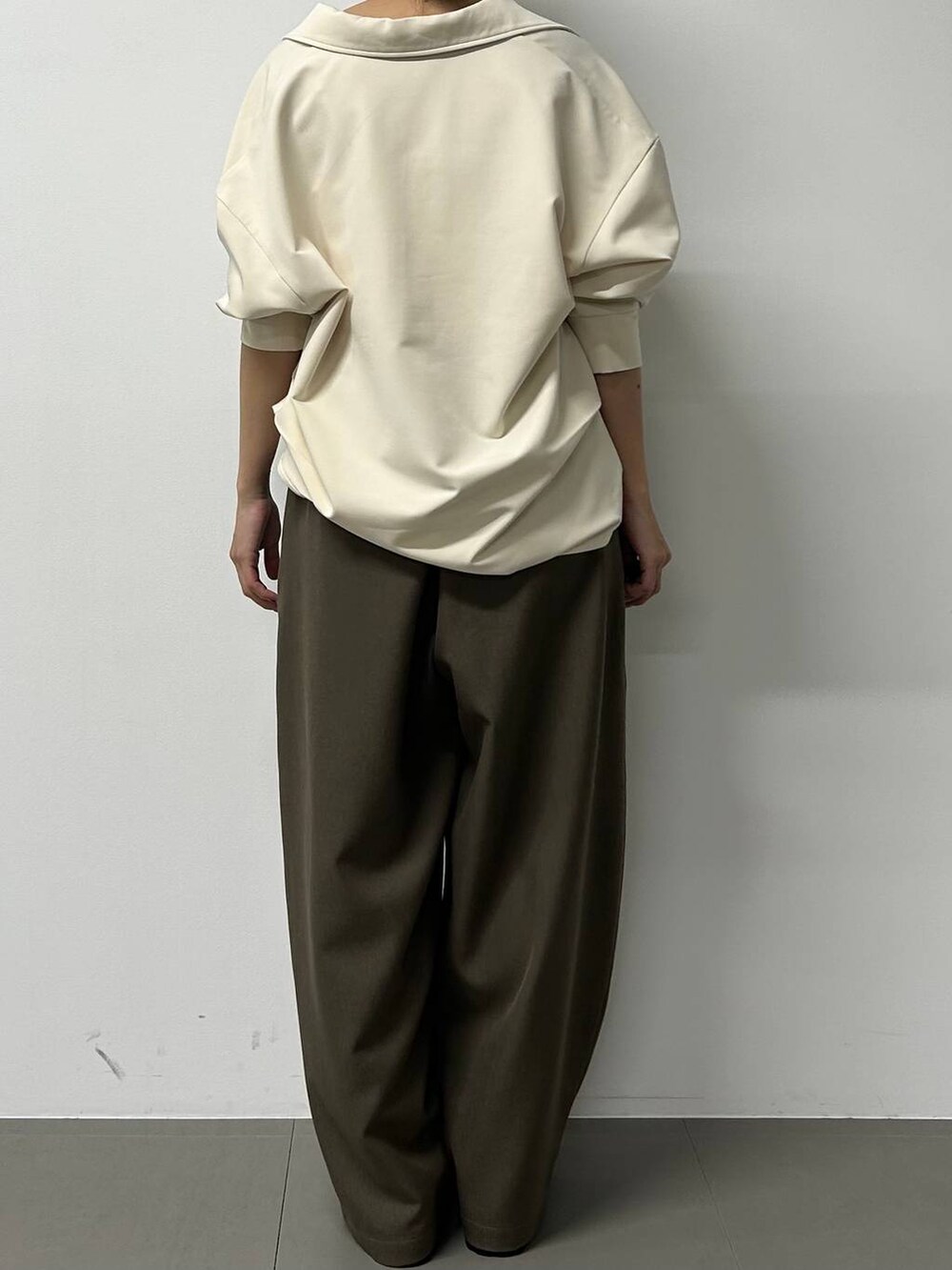 ブラック系のボストンバッグ、ブラック系のローファー、グレー系のスラックスを着用したレディースの秋コーディネートの3枚目の写真