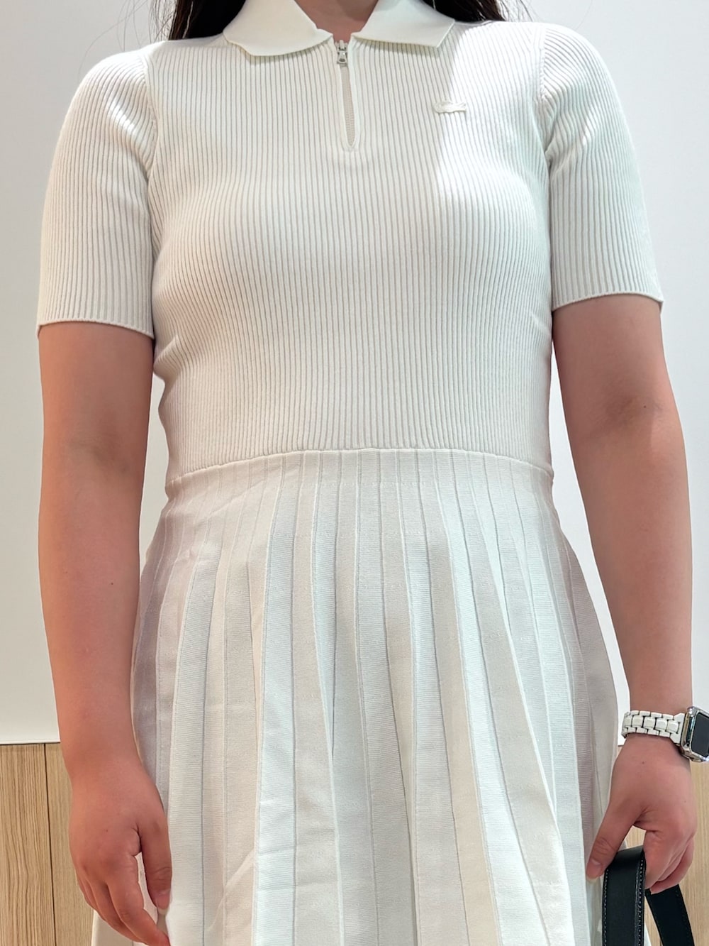 ホワイト系のワンピース、ブルー系のデニムパンツ、グレー系のスニーカーを着用したレディースの夏コーディネートの3枚目の写真