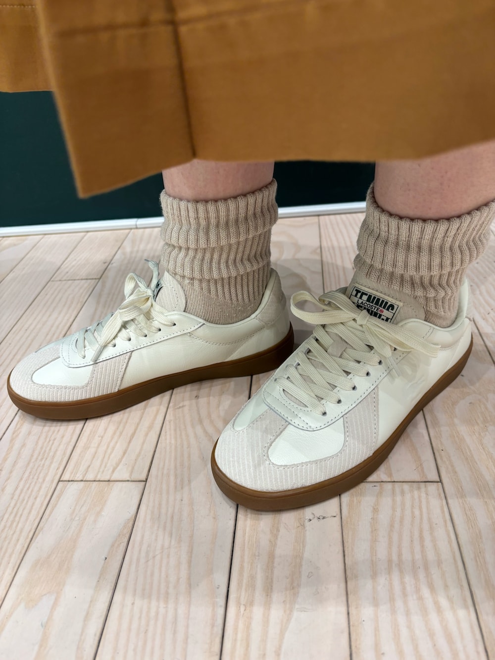 ホワイト系のニット/セーター、イエロー系のスカート、ピンク系のハンドバッグを着用したレディースの秋コーディネートの5枚目の写真
