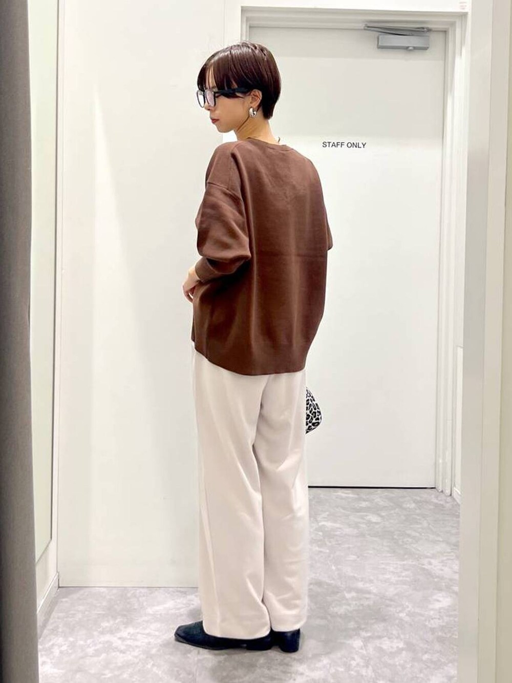 その他のショルダーバッグ、ブラウン系のスウェット、ホワイト系のその他パンツを着用したレディースの秋コーディネートの4枚目の写真