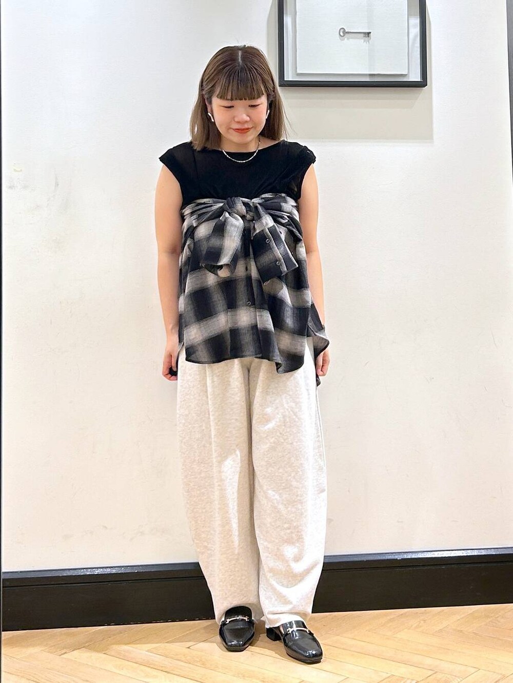 ブラック系のローファー、グレー系のスウェットパンツ、ブラック系のTシャツ/カットソーを着用したレディースの夏コーディネートの2枚目の写真
