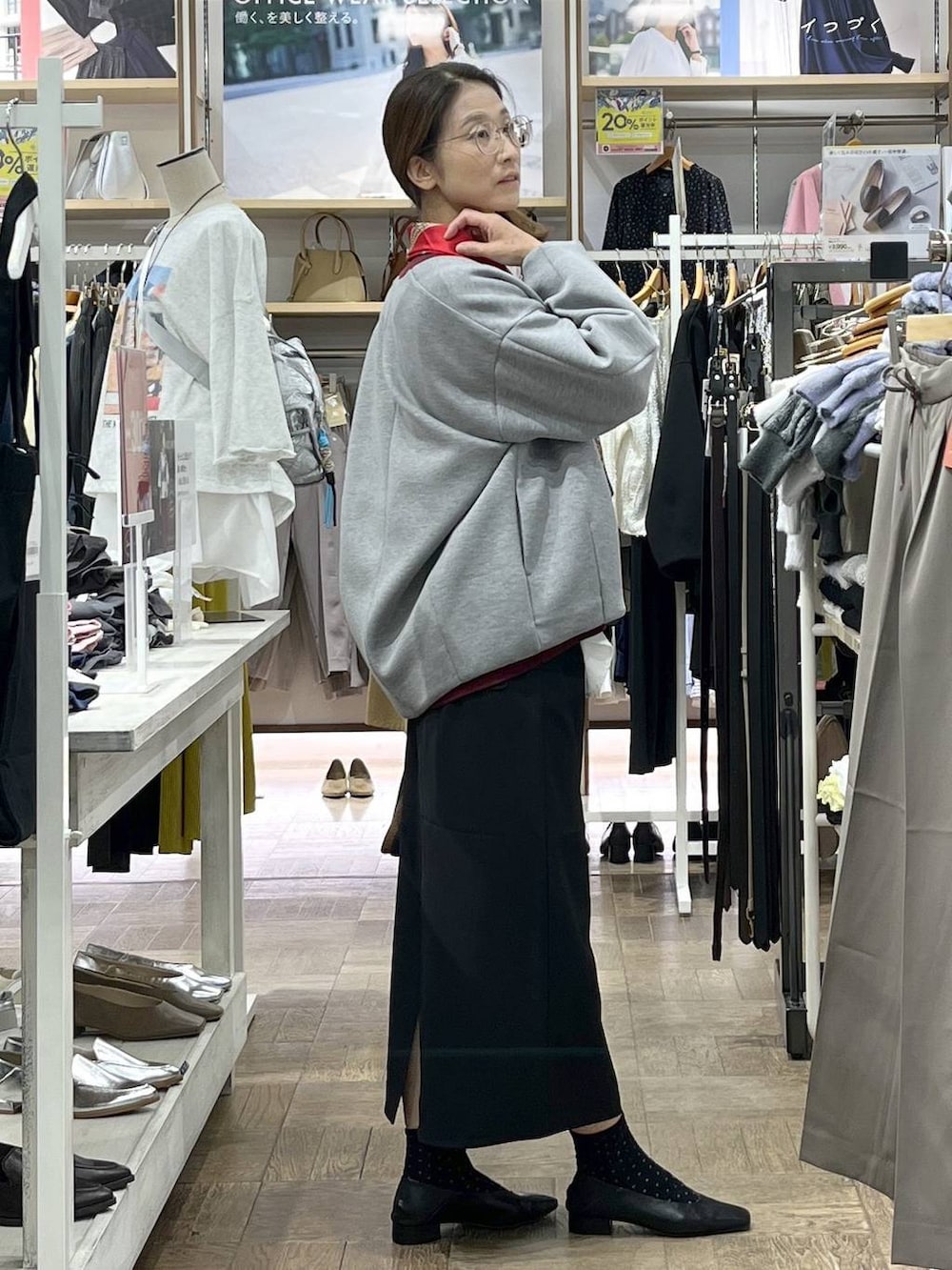 ブラック系のスカート、ホワイト系のシャツ/ブラウス、レッド系のスウェットを着用したレディースの秋コーディネートの2枚目の写真