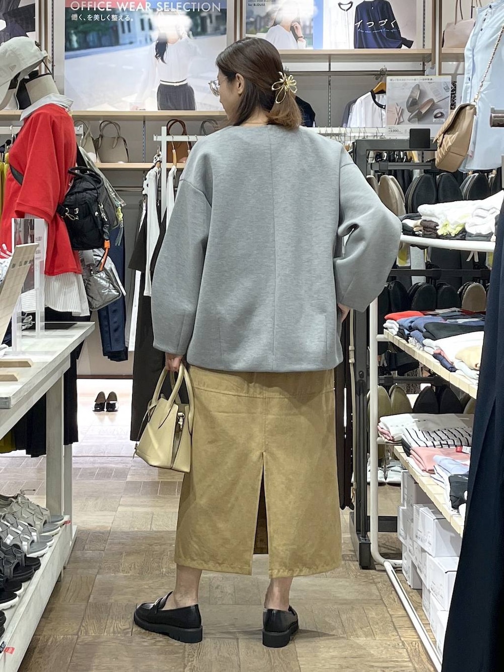 ベージュ系のショルダーバッグ、ブラック系のローファー、グレー系のブルゾンを着用したレディースの秋コーディネートの3枚目の写真