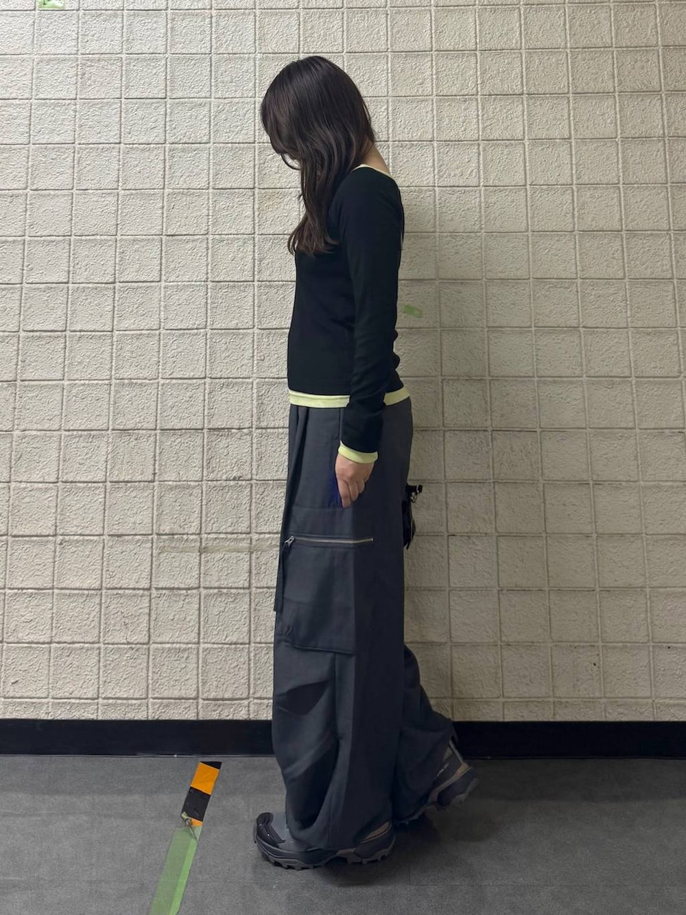 グレー系のカーゴパンツ、ブラック系のTシャツ/カットソー、ブラック系のショルダーバッグを着用したレディースの秋コーディネートの6枚目の写真