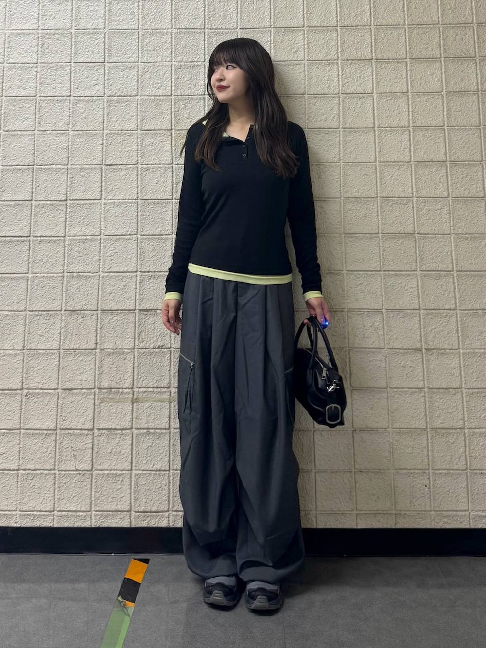 グレー系のカーゴパンツ、ブラック系のTシャツ/カットソー、ブラック系のショルダーバッグを着用したレディースの秋コーディネートの7枚目の写真